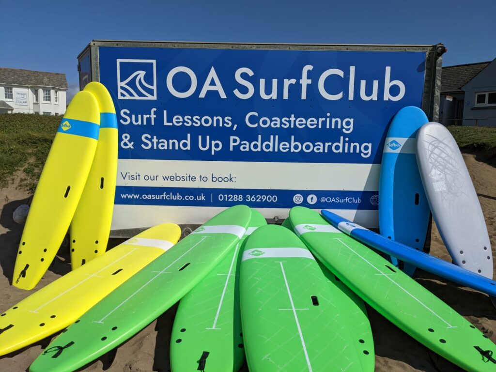 surfing hire. Surfboard trailer with foam surfboards piled in front